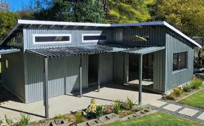 Modular home with a covered veranda and garden